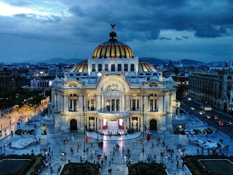 Stunning aerial view of Palacio de Bellas Artes with cityscape at dusk. A prime travel destination and cultural landmark.